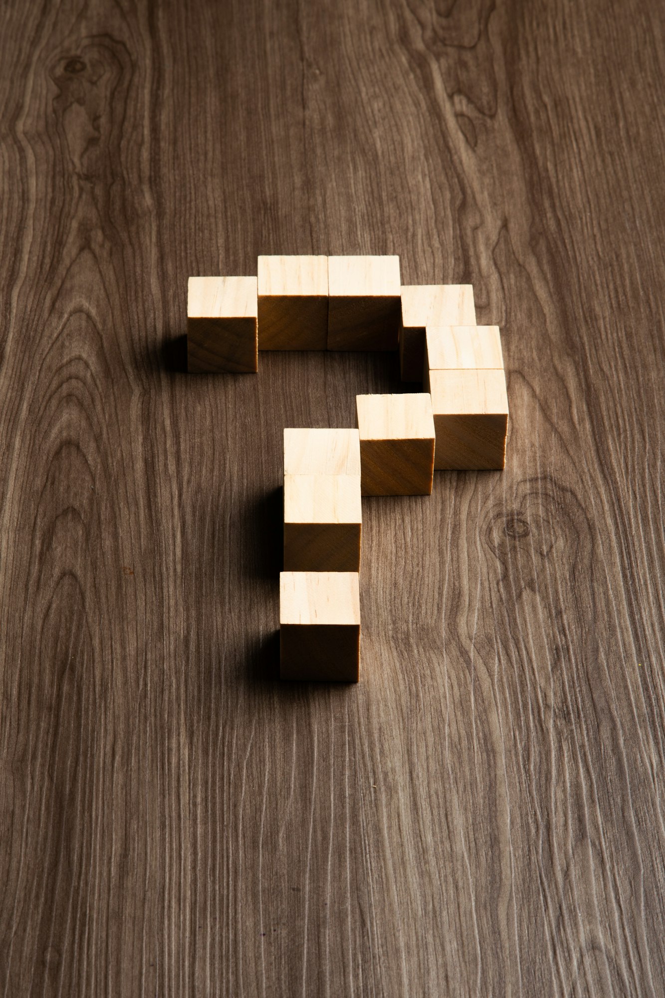 Forming bigger question mark. question mark on wooden table background